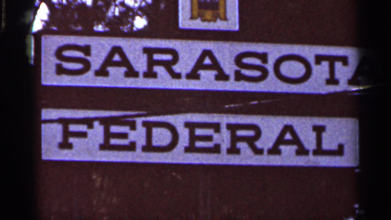 Tight 1966 home-movie view of the Sarasota Federal sign, showing large block lettering and the SFS logo near the top.