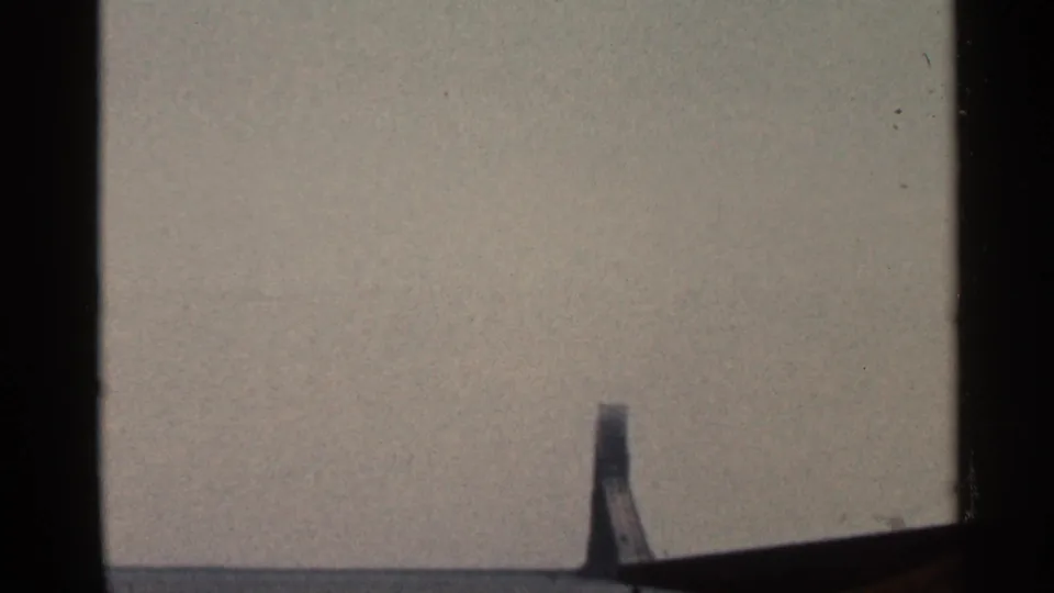 Final 8mm frame appears mostly blank, with muted gray exposure, dark side borders, and a small partial shape along the lower edge.
