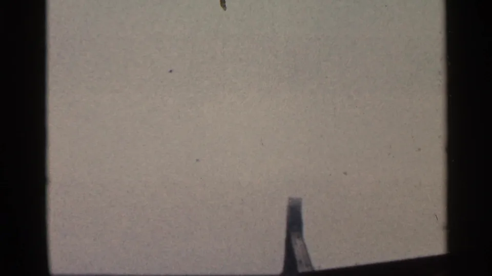 1966 Florida 8mm frame with dark gate borders, muted sky, and a slender mast or marker partly visible near the bottom edge.