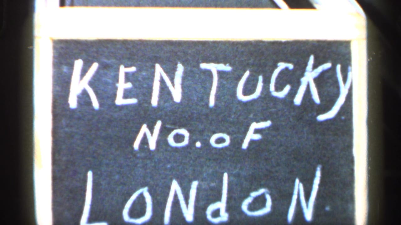Close view of a handwritten sign reading KENTUCKY No. of LONDON on a dark board.