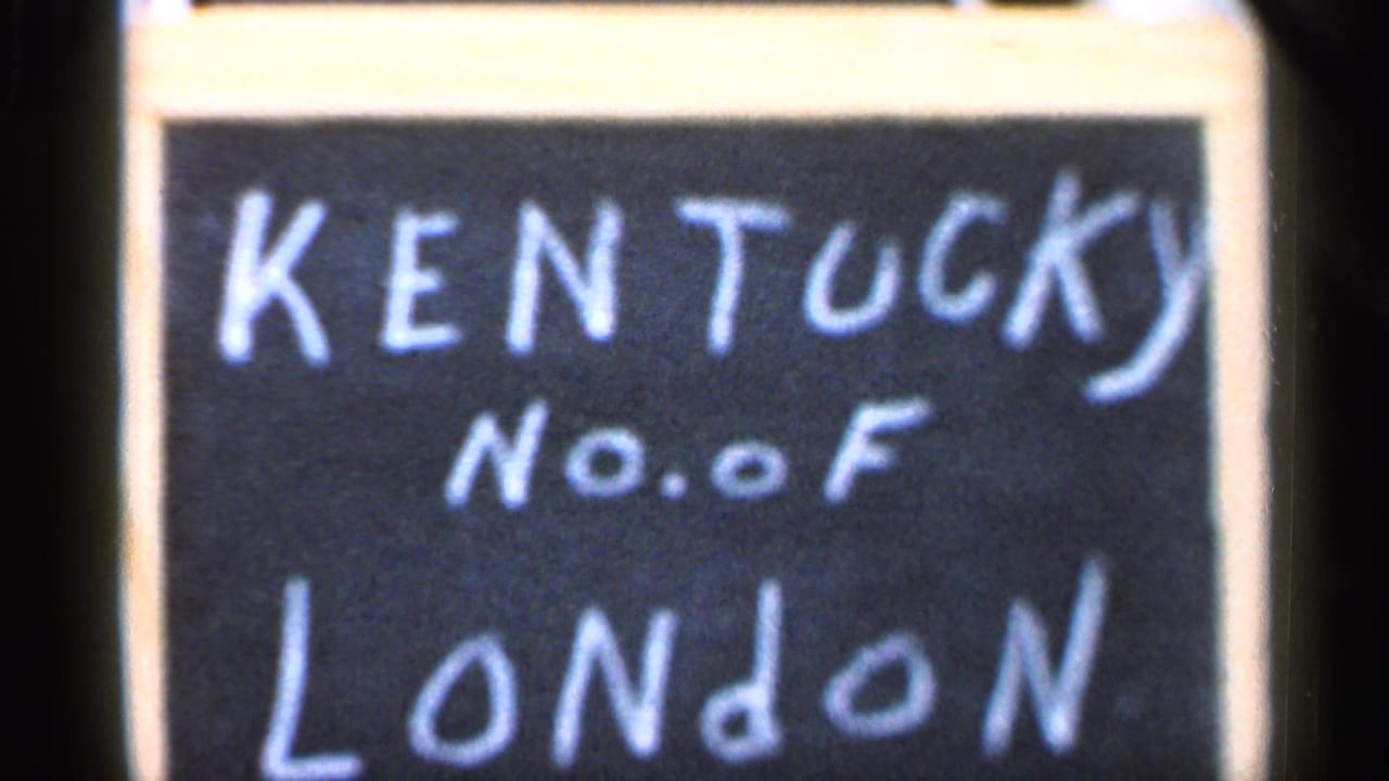 Soft 1966 8mm close-up repeats the chalk-like KENTUCKY No. of LONDON lettering on a dark sign surface.