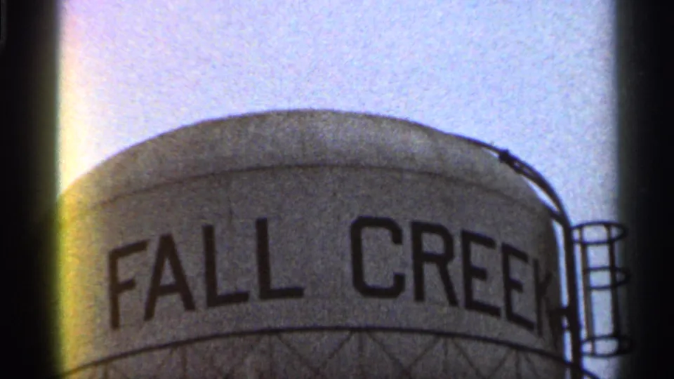 Close 1966 Georgia frame of the FALL CREEK lettering across a large tank, with ladder railings and visible 8mm film border.