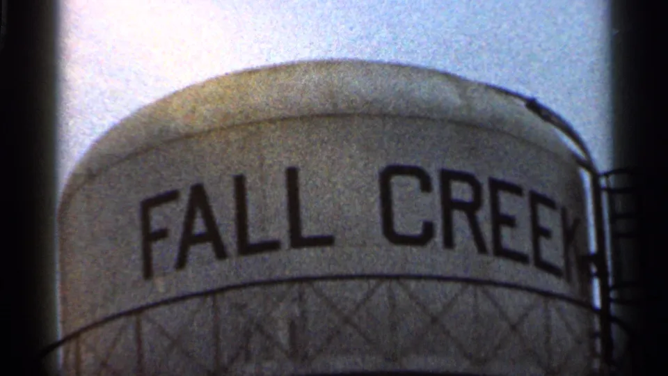 1966 Georgia 8mm frame showing FALL CREEK lettering on a water tower with metal support pattern beneath the tank.