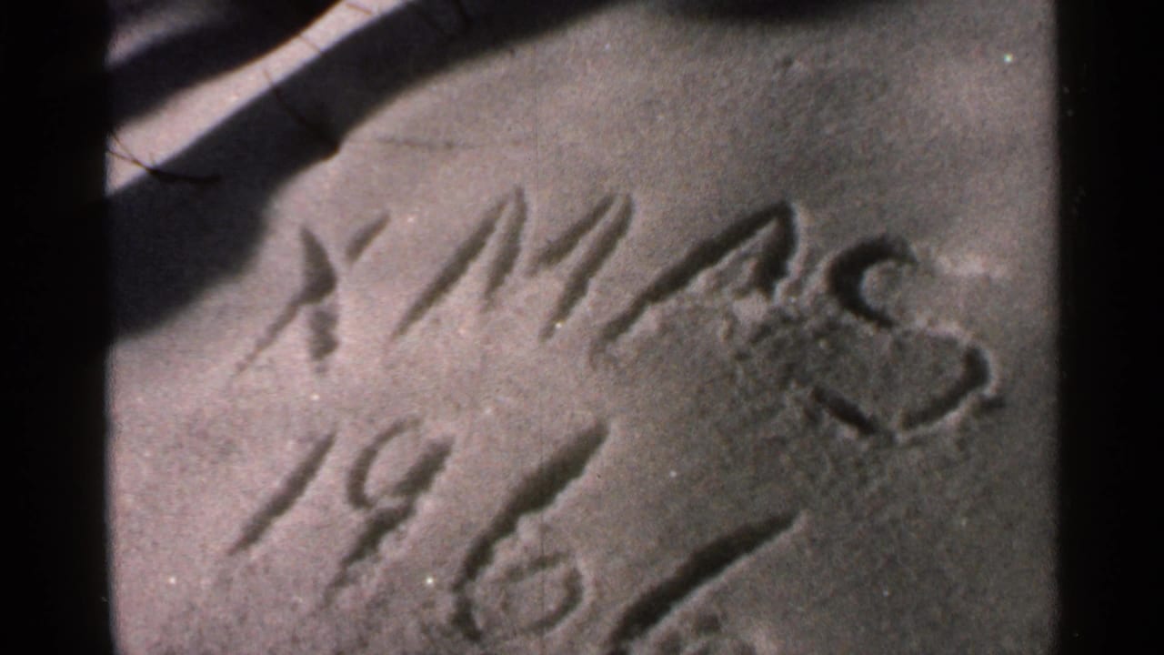 Close-up of “XMAS 1966” on a textured surface, framed by dark film edges.