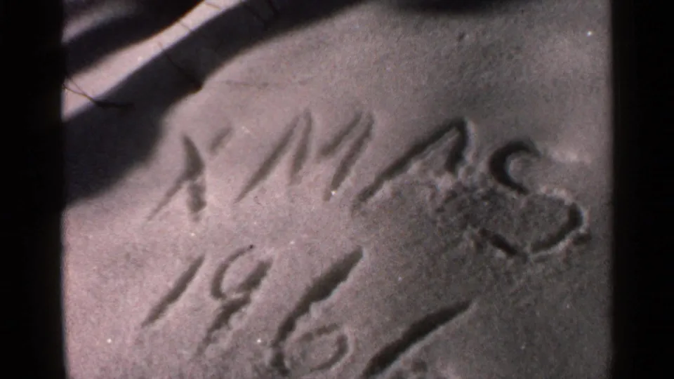 Soft 8mm close-up of the “XMAS 1966” home-movie date marker, likely part of a Georgia Christmas snow sequence.