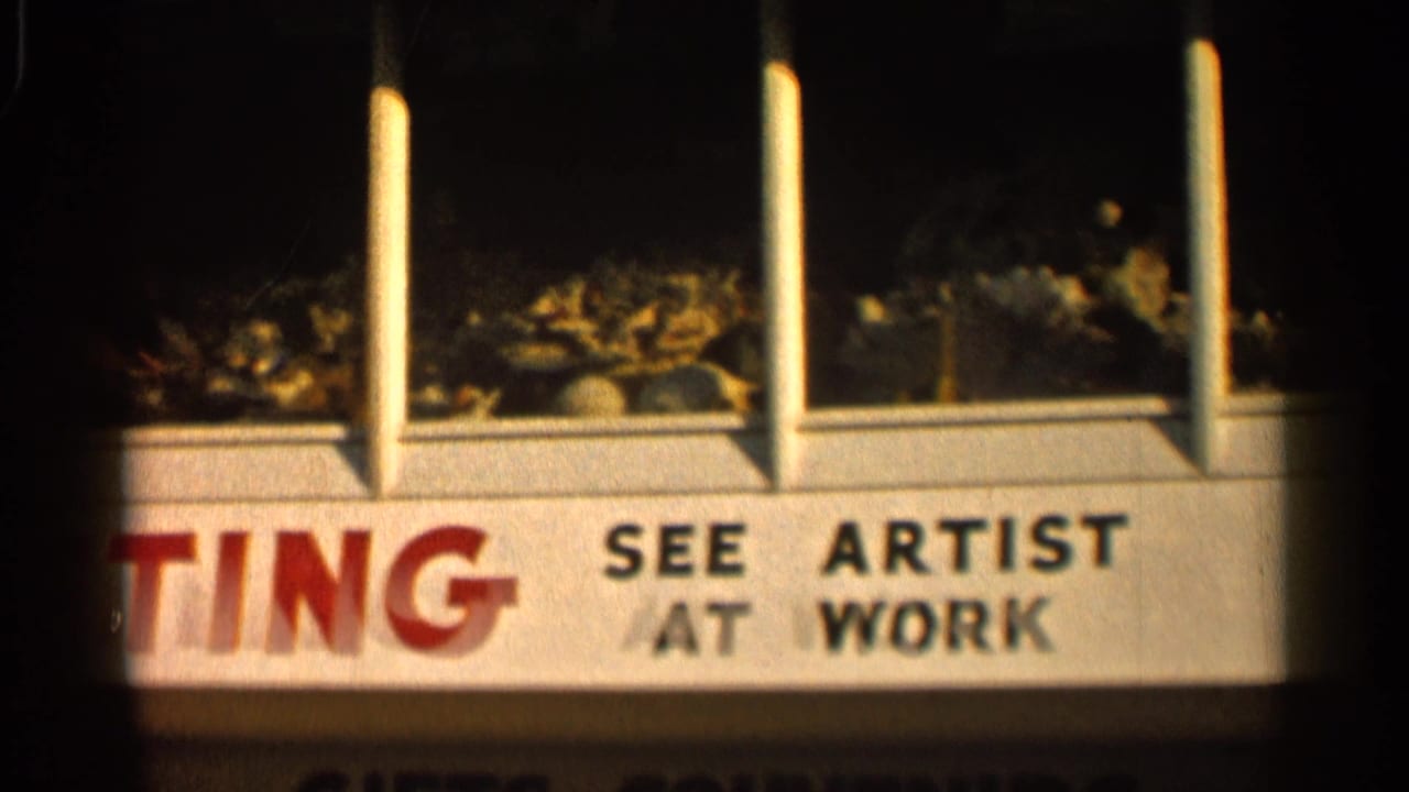 1958 Alabama frame with SEE ARTIST AT WORK text on a white storefront sign and shell displays visible above.