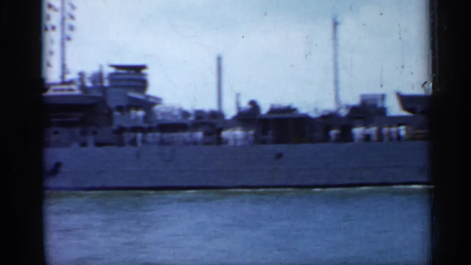 1958 Florida 8mm frame showing the vessel superstructure, deck equipment, and hull from a nearby water-level viewpoint.