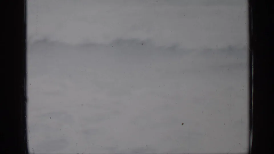 1958 Florida 8mm frame with low, white-tipped waves spreading across a subdued ocean view.