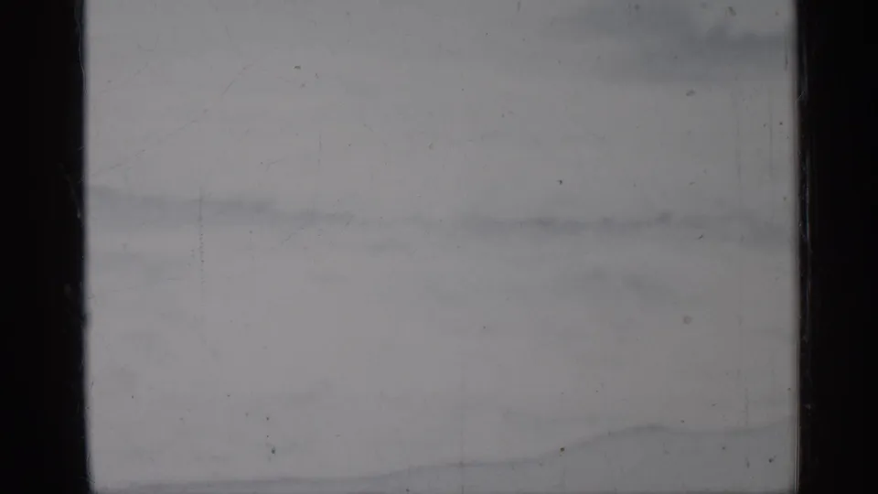 1958 Florida 8mm frame showing muted surf bands and ocean texture with visible film wear.