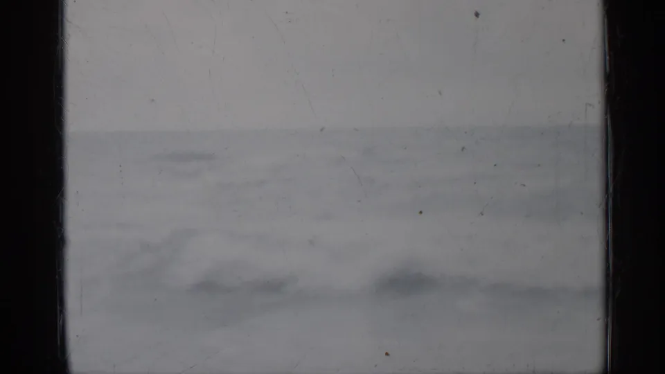 1958 Florida home-movie still showing choppy ocean water, faint whitecaps, pale sky, and visible 8mm film wear.