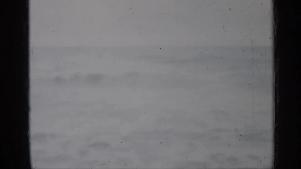 1958 Florida 8mm seascape frame showing rolling water, a soft horizon, pale sky, and aged film texture from the scan.