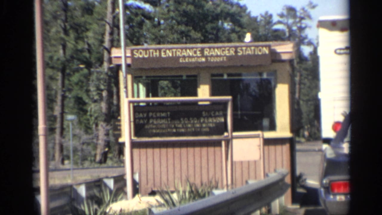 South Entrance Ranger Station booth with permit sign and car at the gate.