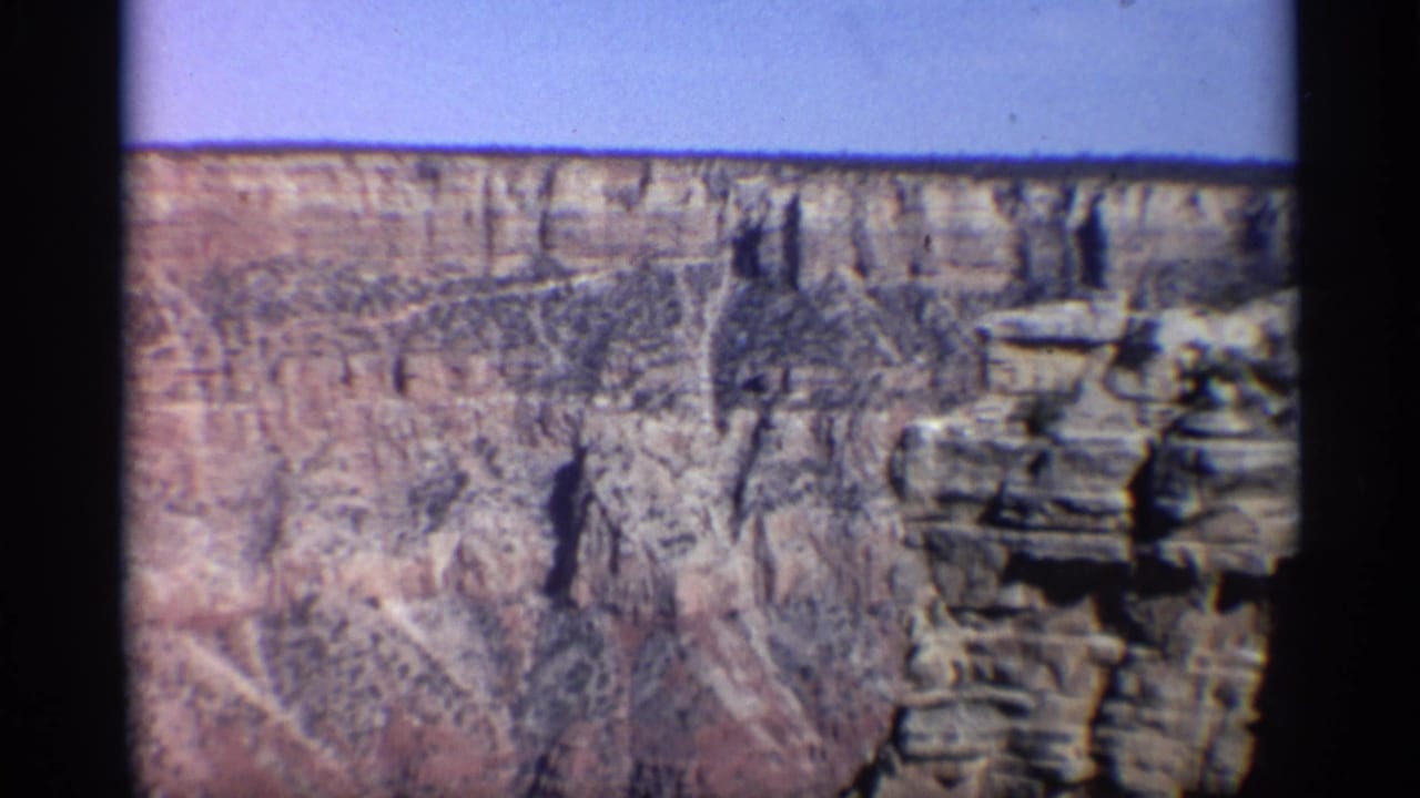 Closer view of canyon cliffs and a projecting rock formation.