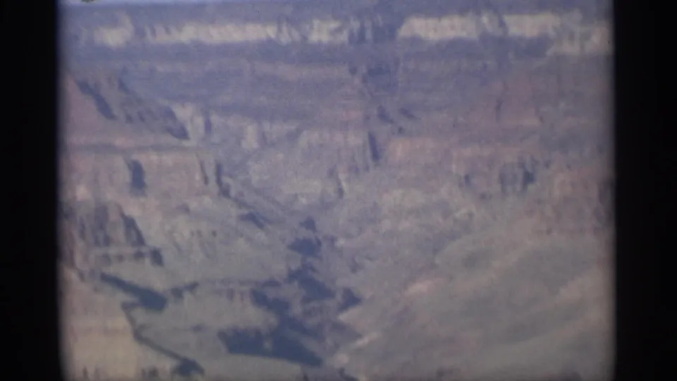 The final 1959 Grand Canyon frame is softer and closer, showing layered cliffs, muted rock color, and deep shadowed ravines.