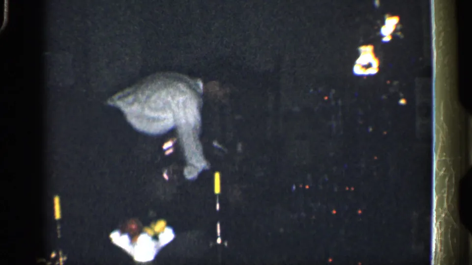 The final frame shows a grainy night view with an indistinct person bending forward near small lights, with the setting difficult to identify.