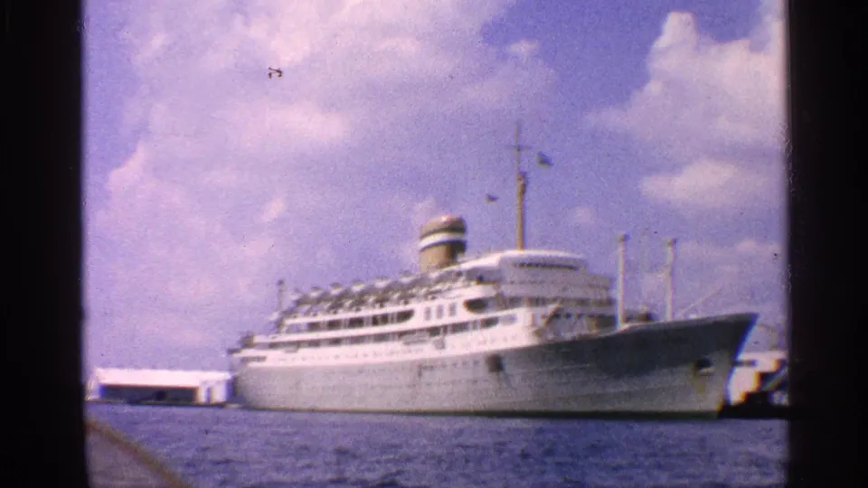 A closer 1959 California view shows the white passenger ship's bow, decks, funnel, and adjacent dock structures.
