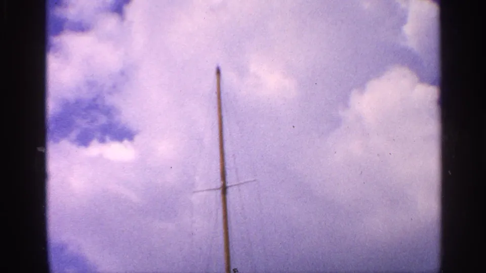 The final frame isolates a sailboat mast and cross spar against a bright cloud-filled sky in 1959 California home-movie footage.