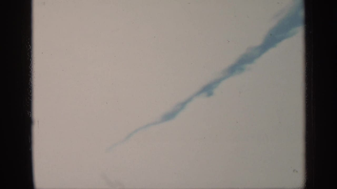 1959 Florida 8mm frame showing abstract blue-white rippling water with soft exposure and visible film borders.