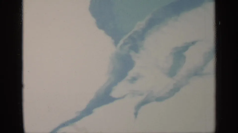 1959 Florida 8mm frame of rippling water patterns, with blue swirls and dark vertical film-frame edges visible.