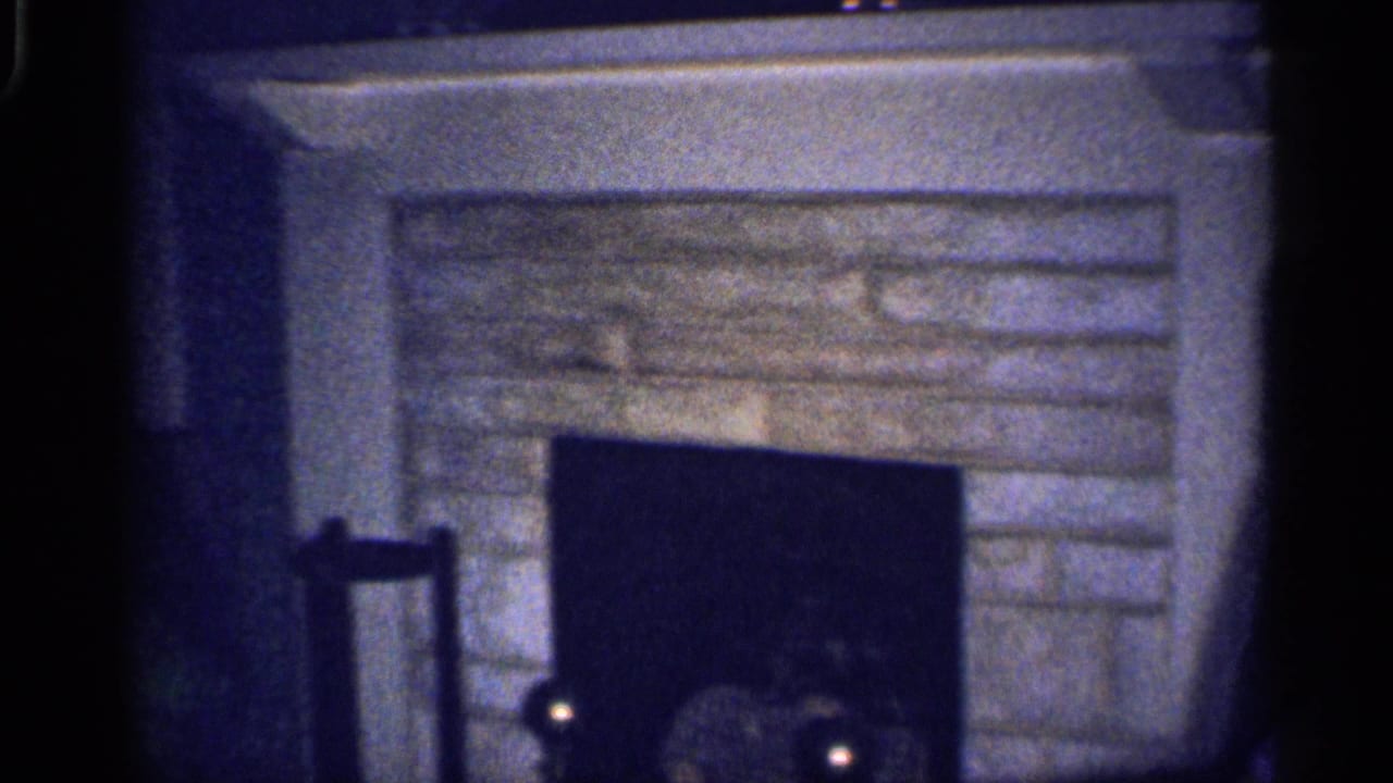 Stone fireplace and dark firebox in a dim living room.