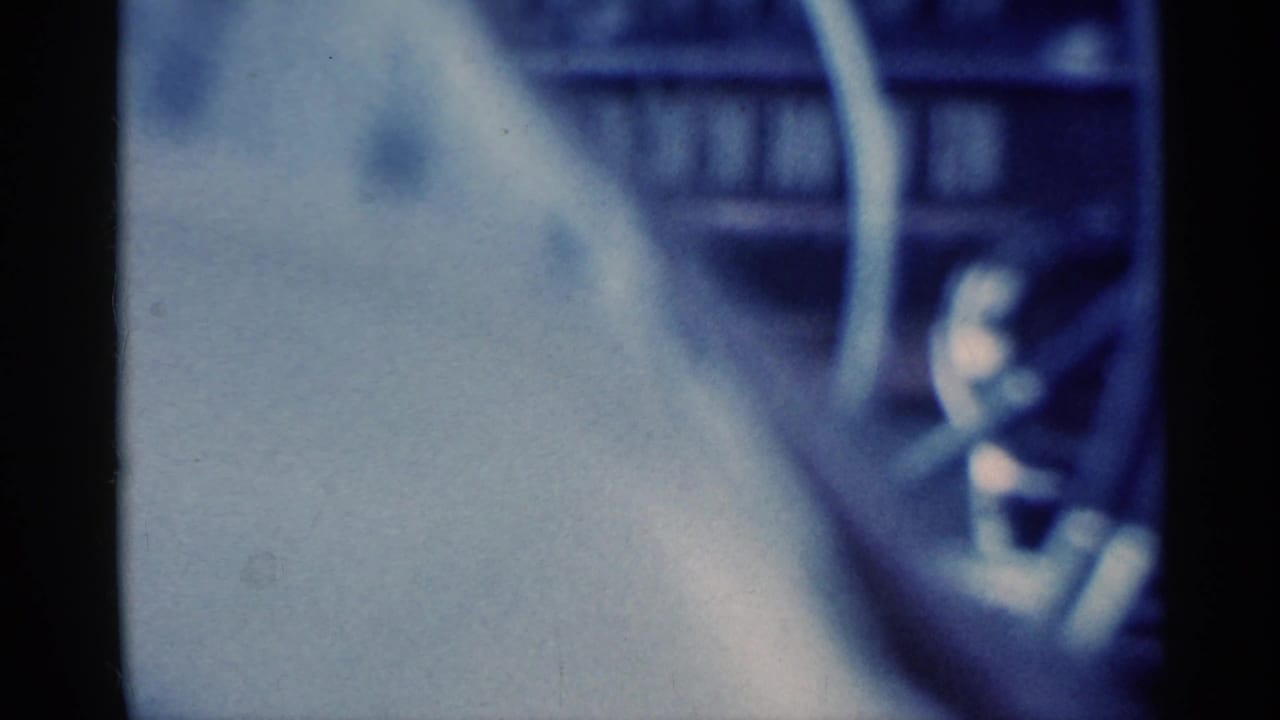 Close, soft-focus view of a steering wheel and dashboard inside a car.