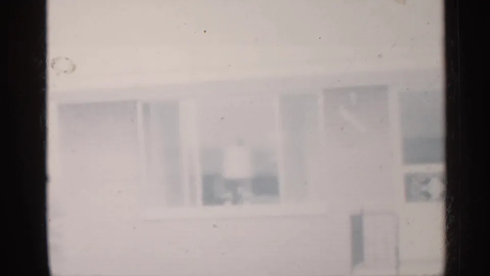 Soft 8mm view of a residential house exterior in Indiana, with windows and pale winter exposure.