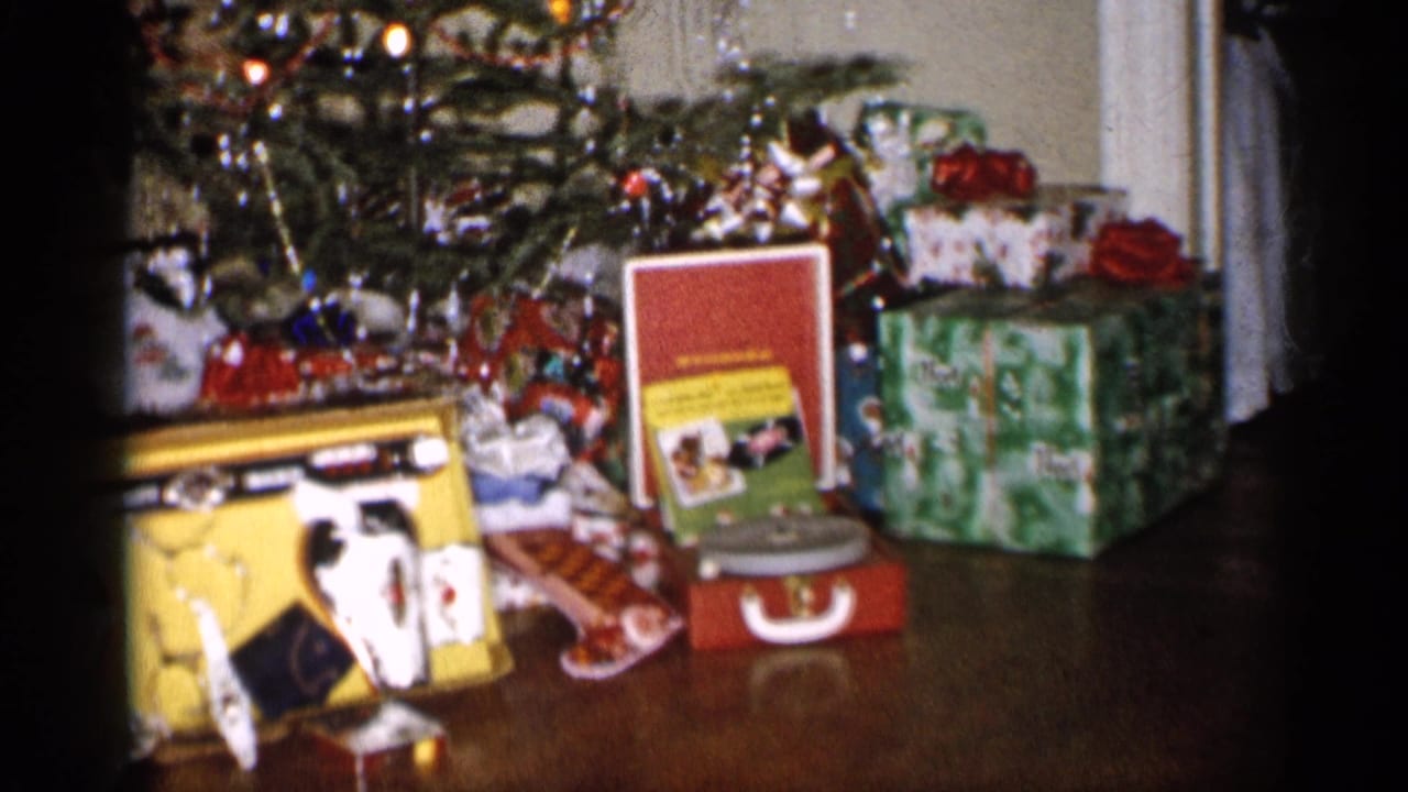 Wrapped gifts and toys beneath a Christmas tree, including a red record player.