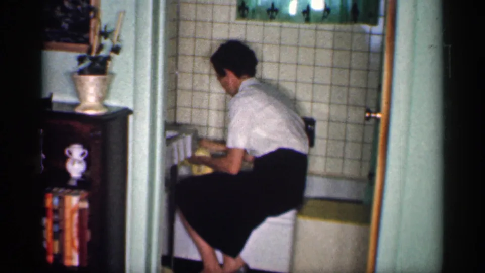 The final frame shows the woman seated beside the bathtub, continuing to clean the tub area with a yellow cloth.