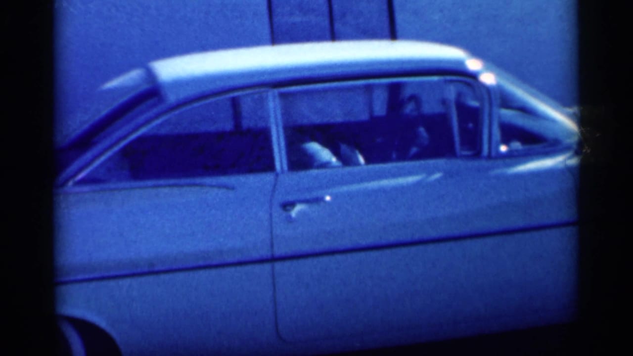 Rear half of a white vintage sedan with side windows and chrome trim.