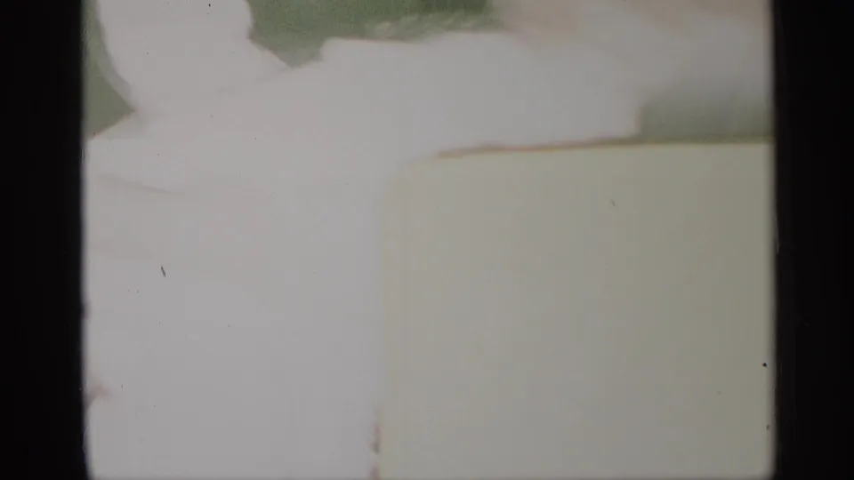 Soft, overexposed 1959 New York home-movie frame with an interior doorway and a partly cropped person.