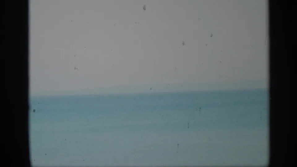 1959 New York 8mm view of sea and pale sky, softened by exposure, dust, and dark frame edges.
