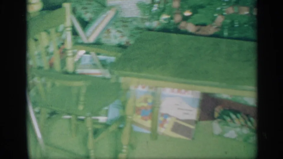 1959 New York home-movie view of a small table, wrapped presents, and holiday items beneath or near a Christmas tree.
