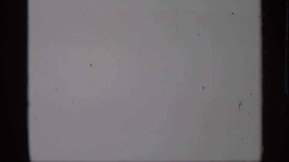 Pale end frame from the 1959 New York 8mm clip, showing little scene detail beyond film marks and border.