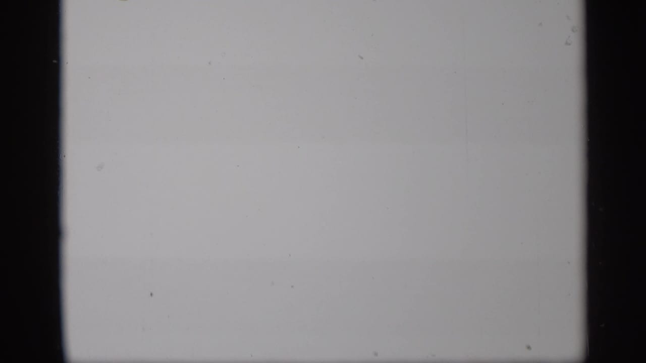 Mostly blank overexposed film frame with dark vertical film borders.