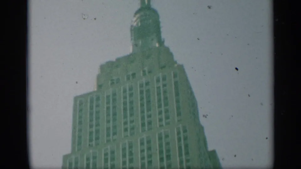 1959 New York frame showing the Empire State Building's upper windows, stepped crown, and spire in soft 8mm color.