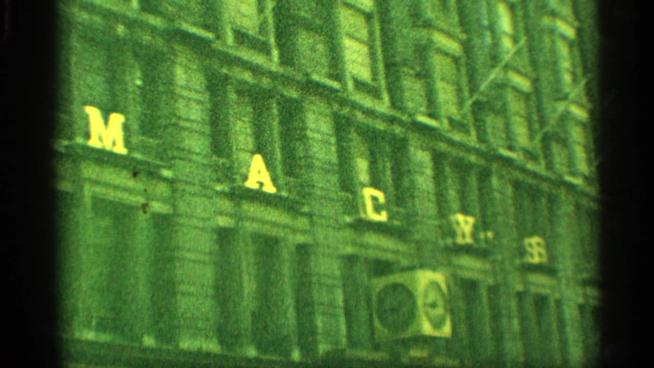 1959 New York home-movie view of the Macy's building facade with large yellow letters across the exterior.