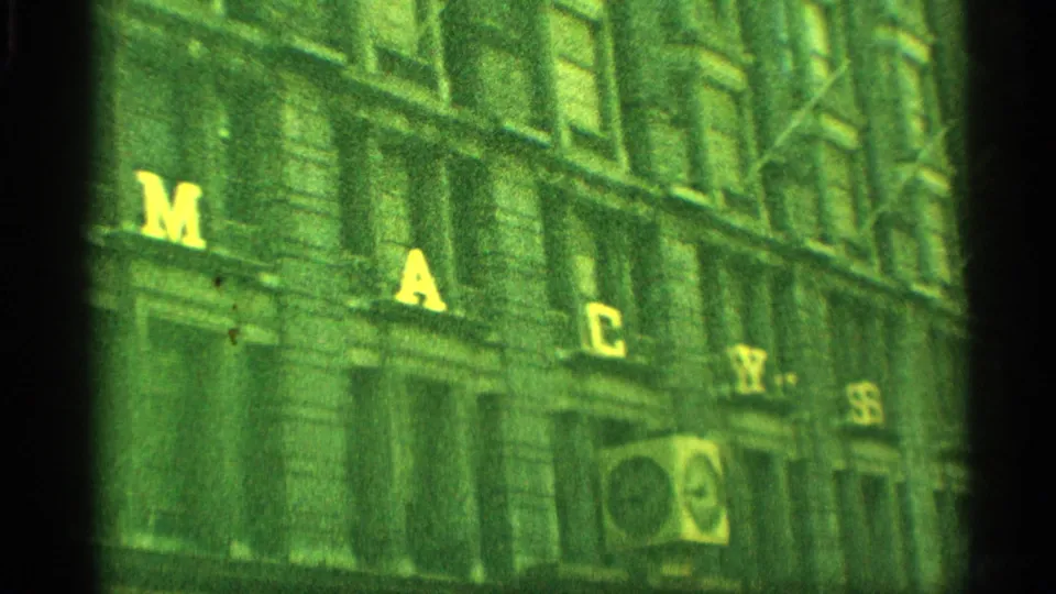 1959 New York home-movie view of the Macy's building facade with large yellow letters across the exterior.