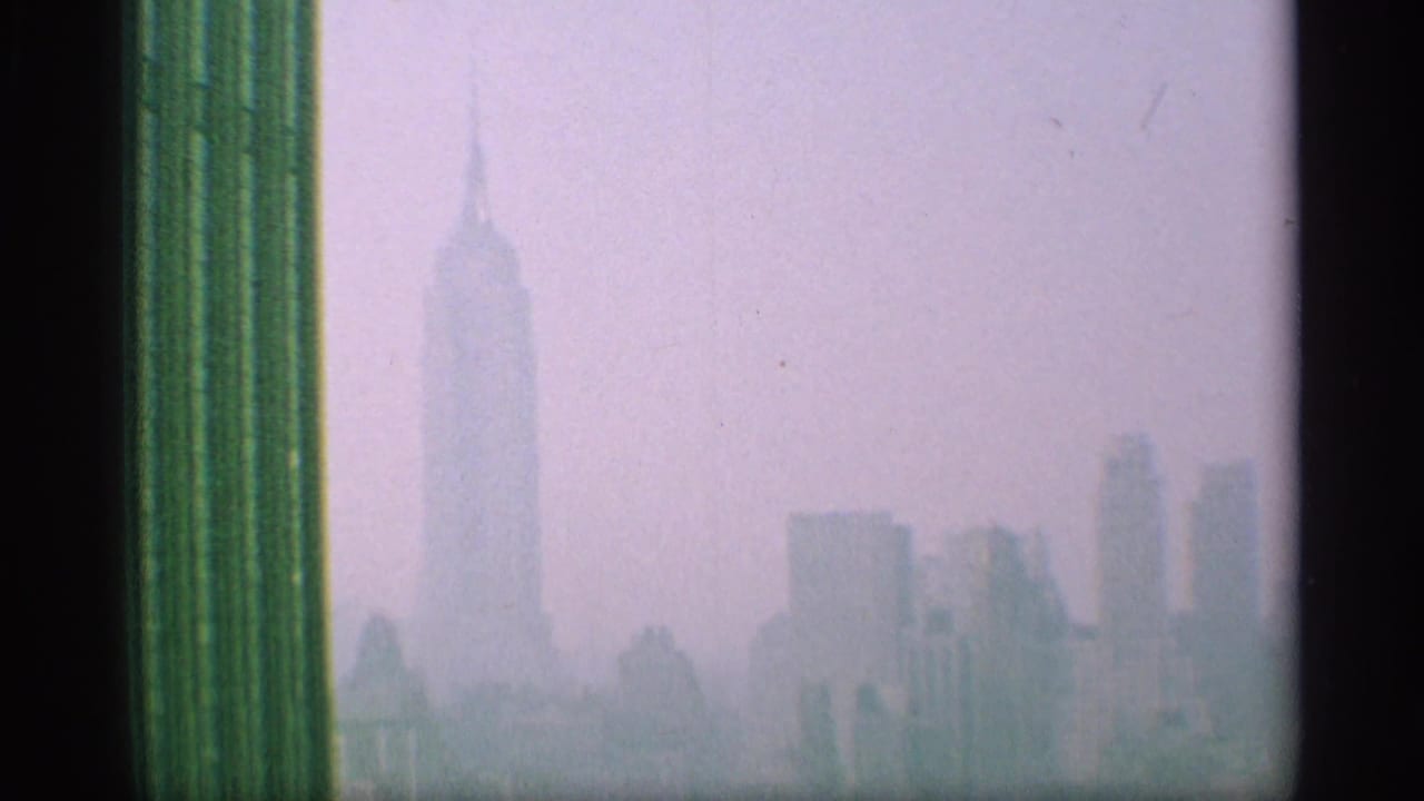 Hazy skyline view with the Empire State Building visible near the center.