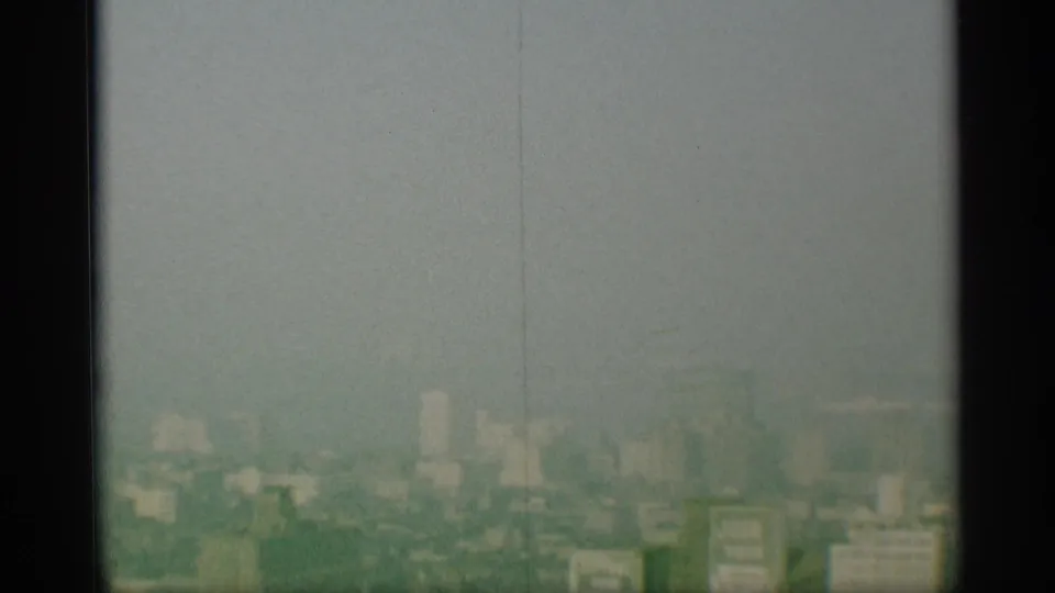 A faded 1959 New York skyline view appears partially obscured by dark vertical framing and film haze.