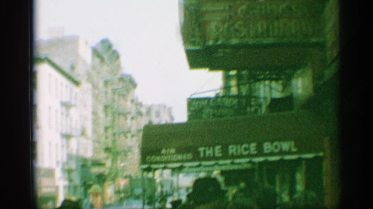 1959 New York street view with the Rice Bowl awning, storefronts, pedestrians, and soft green 8mm film color.