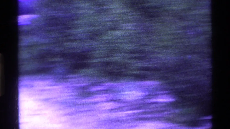 Final 1969 Ohio 8mm frame becomes an abstract blur of snowy roadside color, light streaks, and dark film borders.