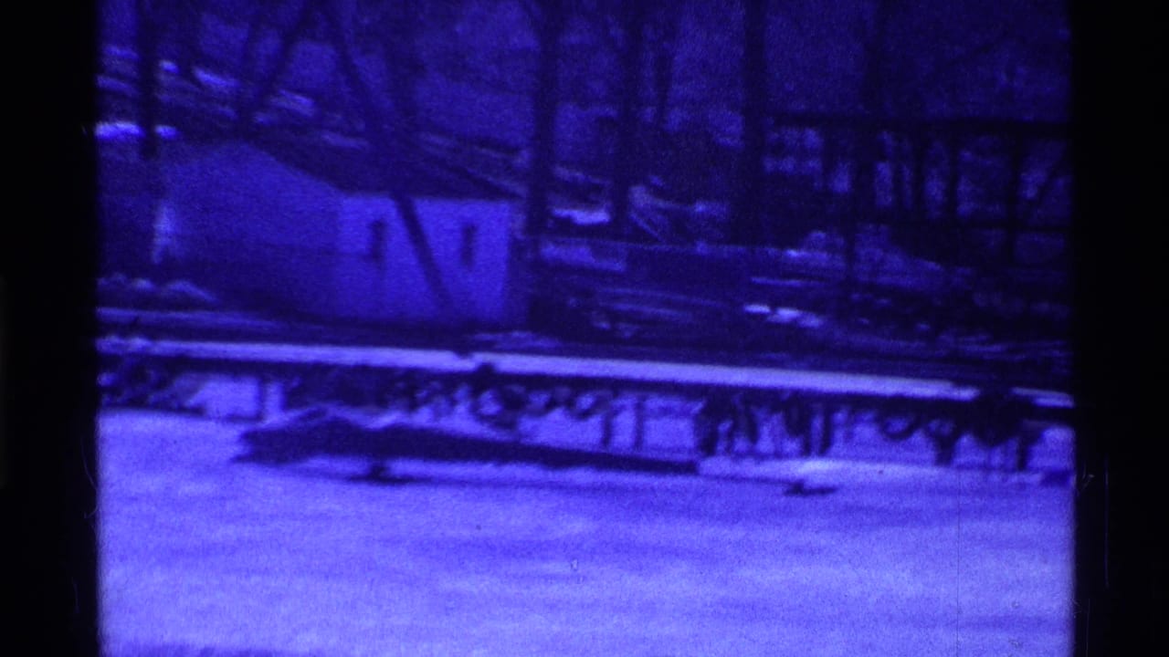 1969 Ohio 8mm frame showing a blue-tinted frozen surface with railing or dock shapes and no visible people.