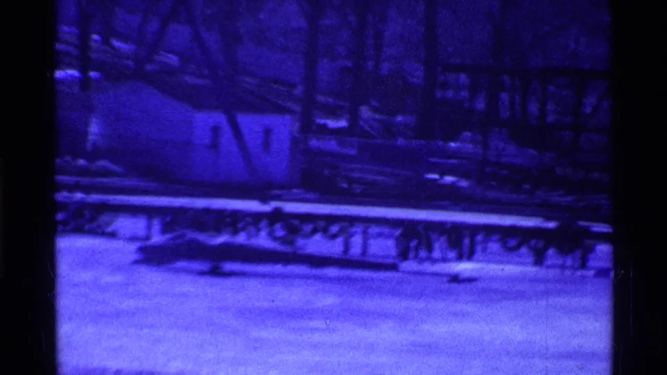 1969 Ohio 8mm frame showing a blue-tinted frozen surface with railing or dock shapes and no visible people.