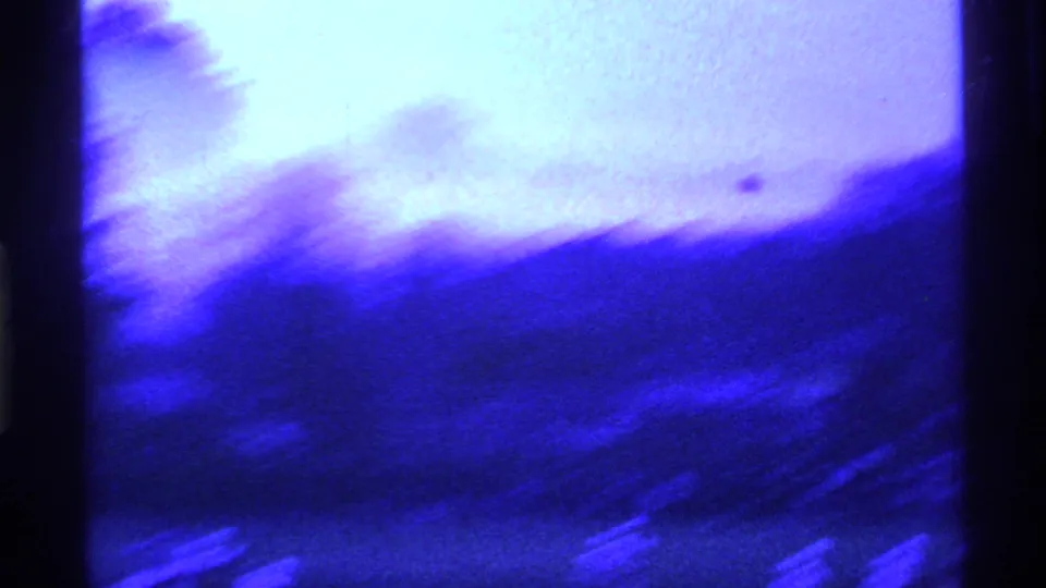 Motion-blurred 1969 Ohio home-movie frame as the camera follows football action across the field.