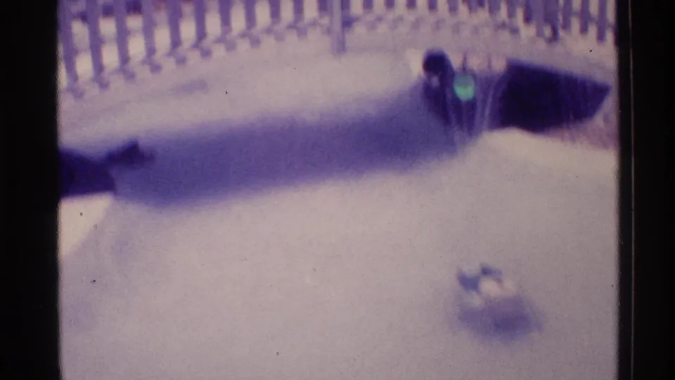 1973 Florida 8mm frame of a fountain area with a curved railing and a small floating object on the water.