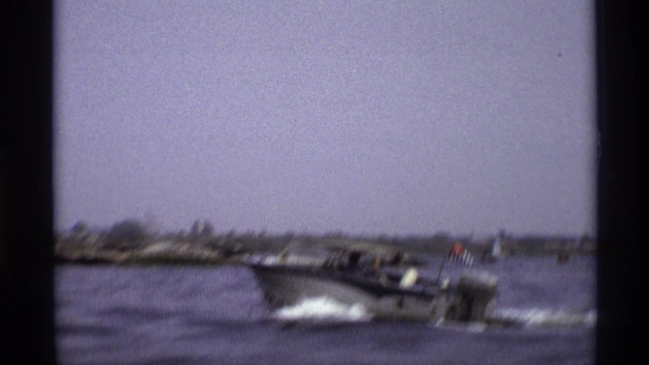 1973 New York home-movie frame showing the speedboat in profile as it throws spray across the water.
