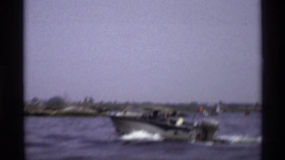 1973 New York home-movie frame showing the speedboat in profile as it throws spray across the water.