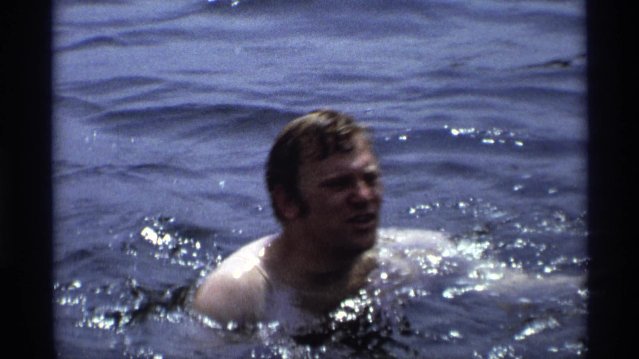 Close view of a man swimming through rippling water.