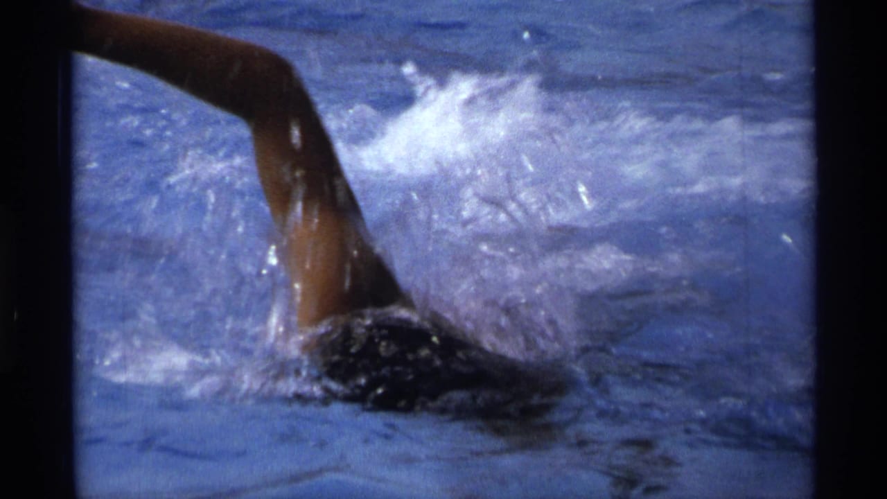 1973 New York pool footage showing a swimmer's arm above the water during freestyle movement.