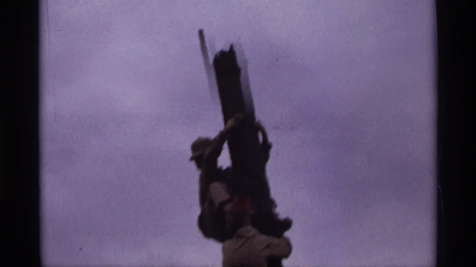 1974 Orlando 8mm frame with a silhouetted elephant form and raised trunk, partly obscured by exposure and motion blur.